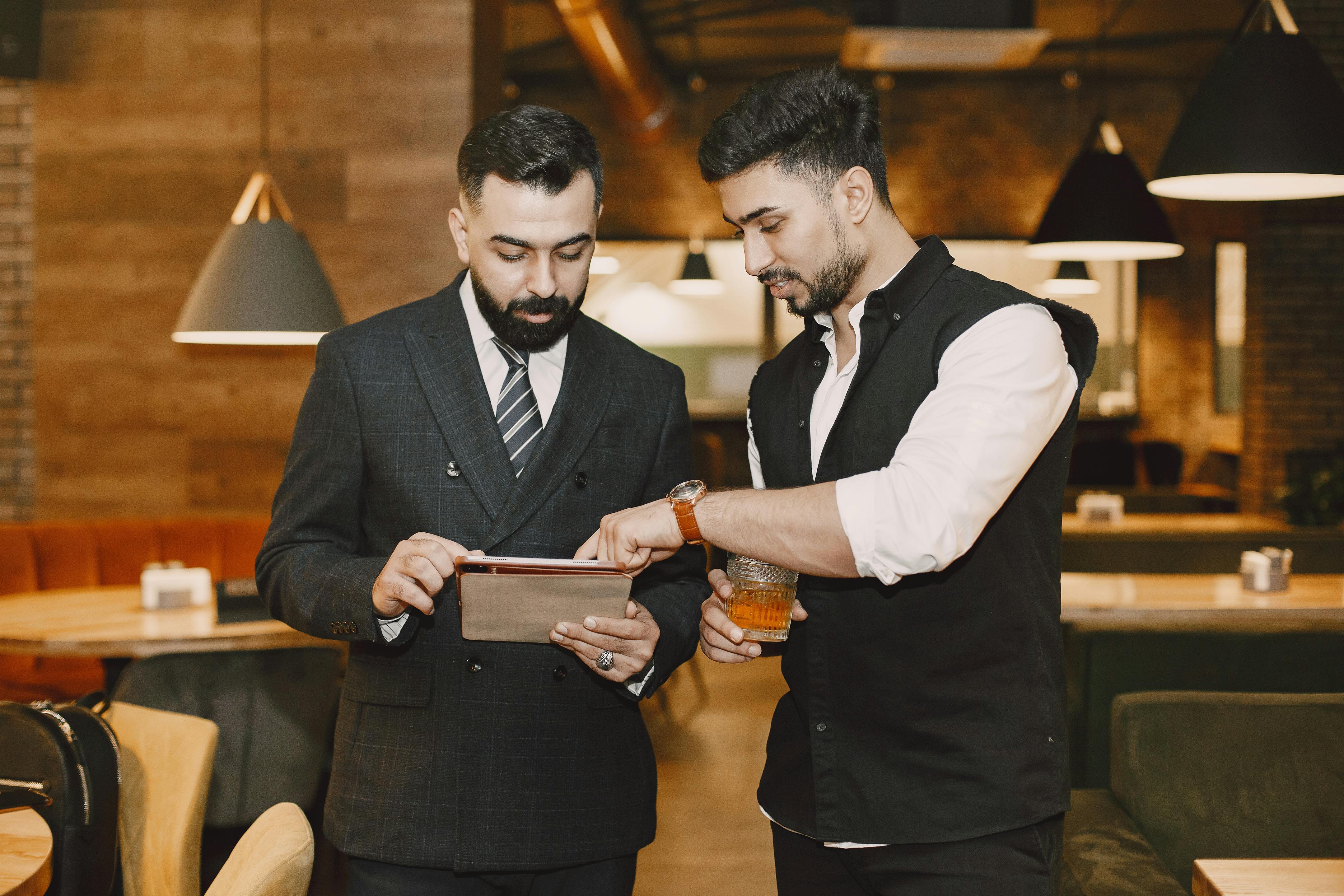 Small business operators reviewing work on a tablet